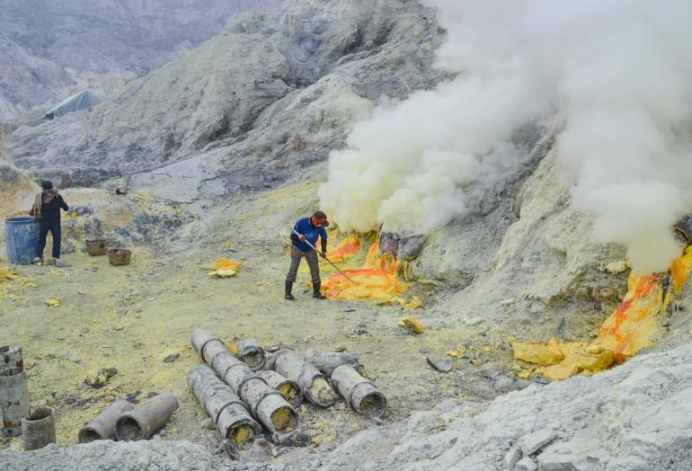 Ijen miner in kawah Ijen volcano Indonesia